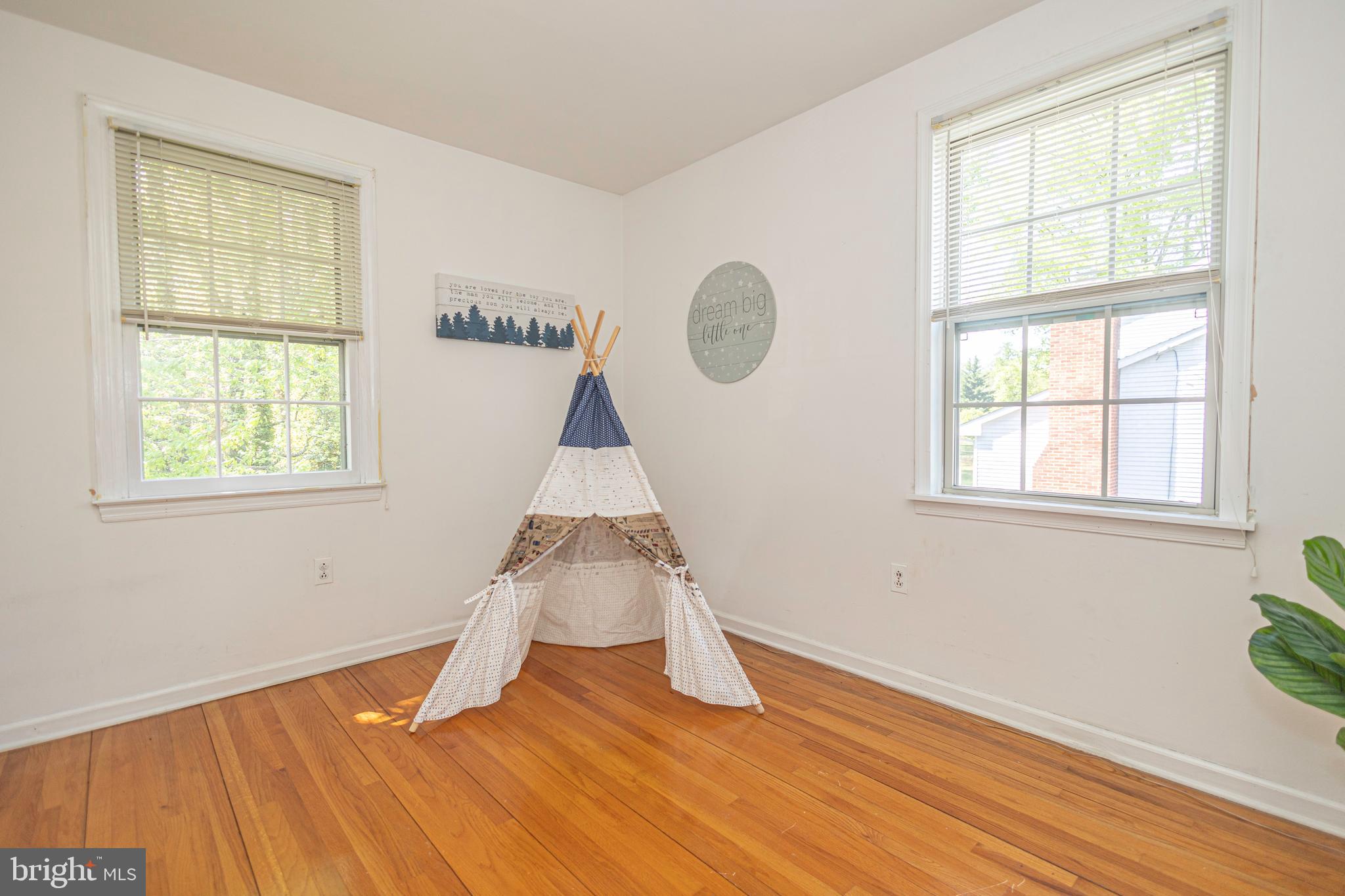 2316 Shipley Road Wilmington, DE 19803 - Photo 23 of 42 an empty room with wooden floor and windows