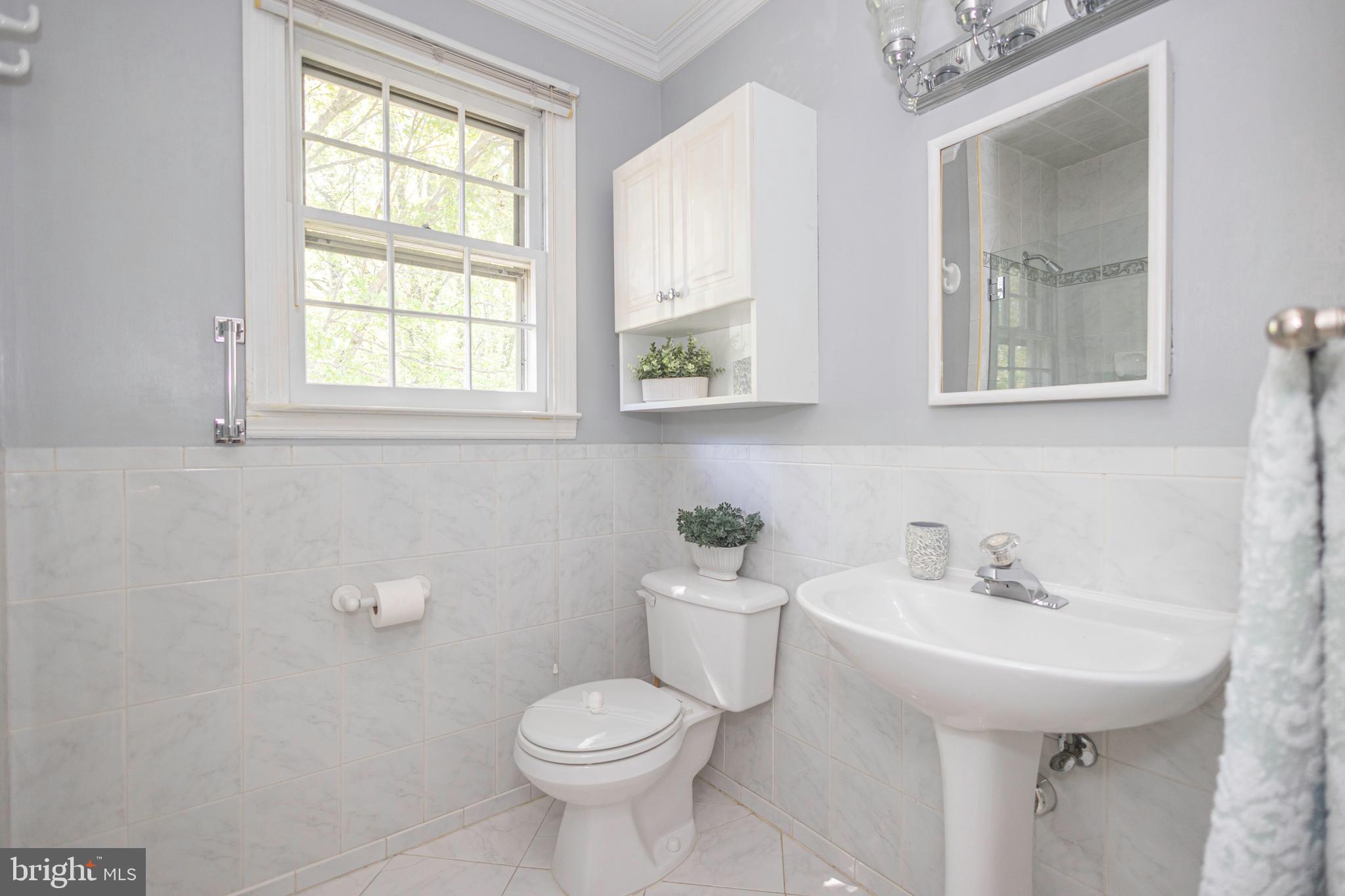 2316 Shipley Road Wilmington, DE 19803 - Photo 27 of 42 a bathroom with a toilet sink and mirror