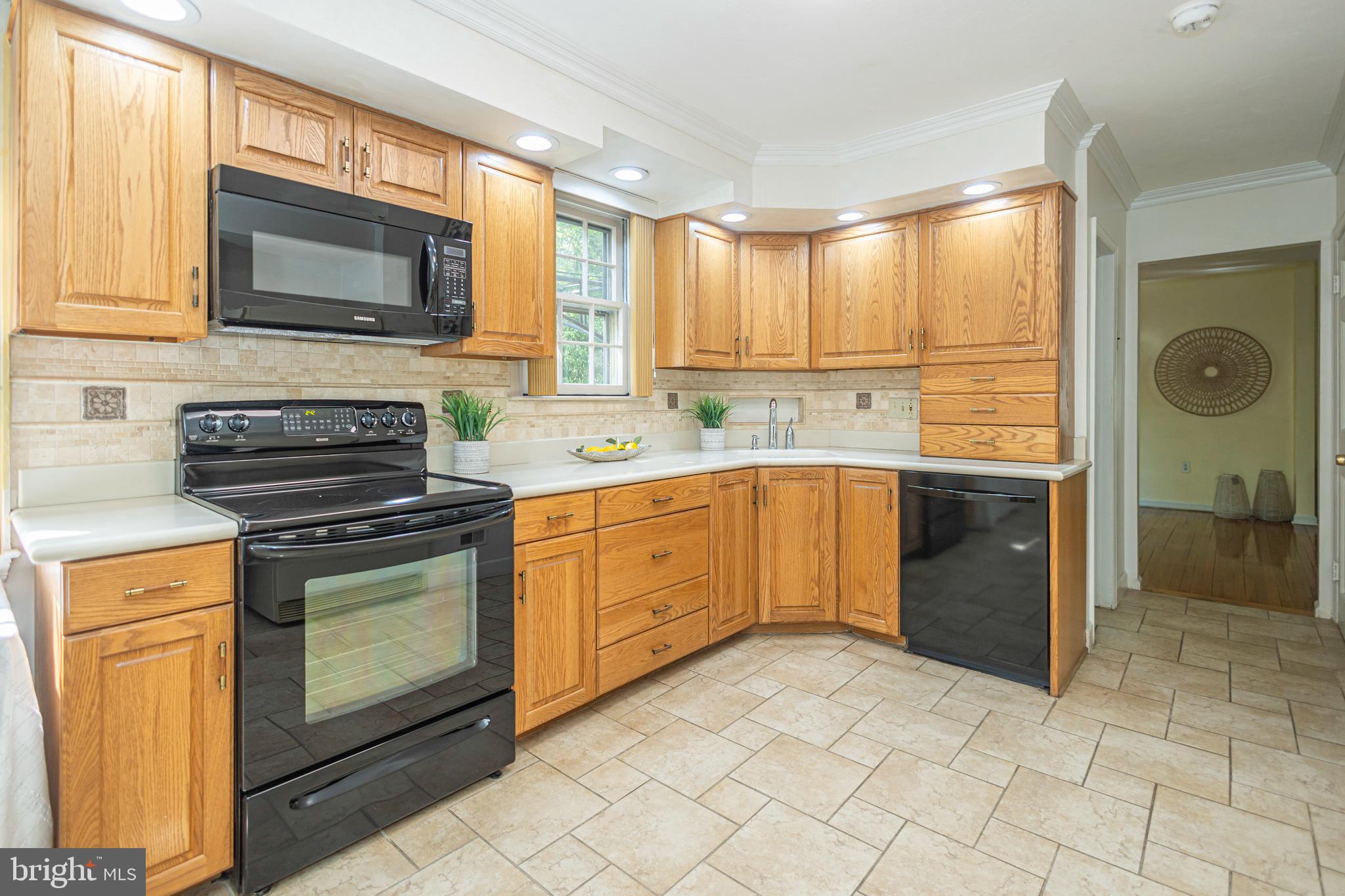 2316 Shipley Road Wilmington, DE 19803 - Photo 8 of 42 a kitchen with stainless steel appliances granite countertop a stove a sink and a microwave