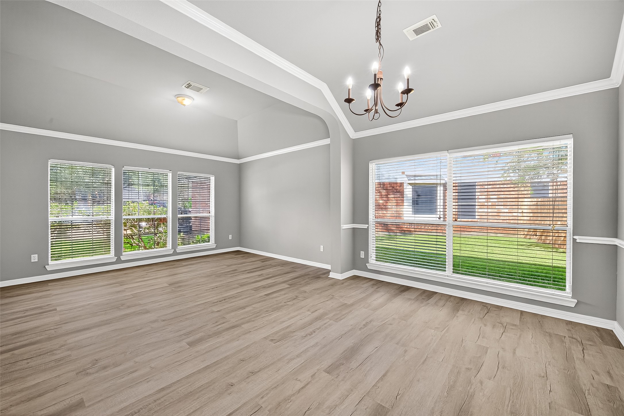 17230 Valhallah Way Houston, TX 77095 - Photo 9 of 48 a view of an empty room with wooden floor and a window