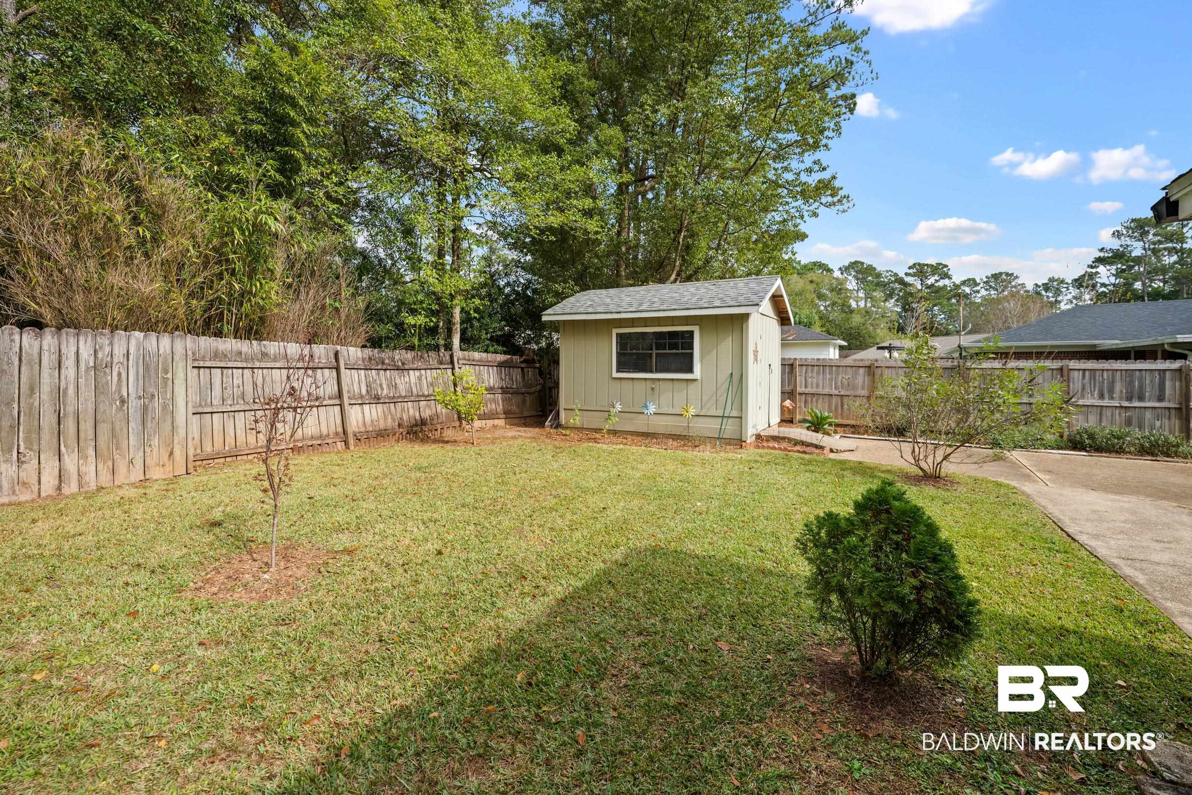 123 Dunbar Loop Daphne, AL 36526 - Photo 30 of 33 Fenced backyard featuring an outbuilding