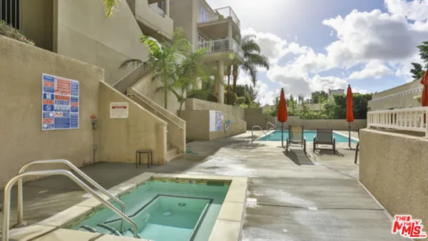 a view of a patio with couches table and chairs and potted plants