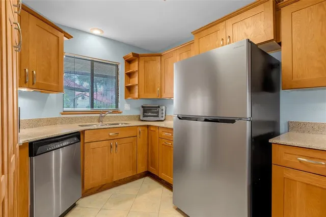 a kitchen with stainless steel appliances a refrigerator and a sink