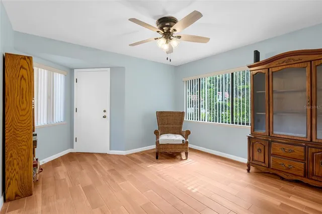 a workspace with wooden floor and a window