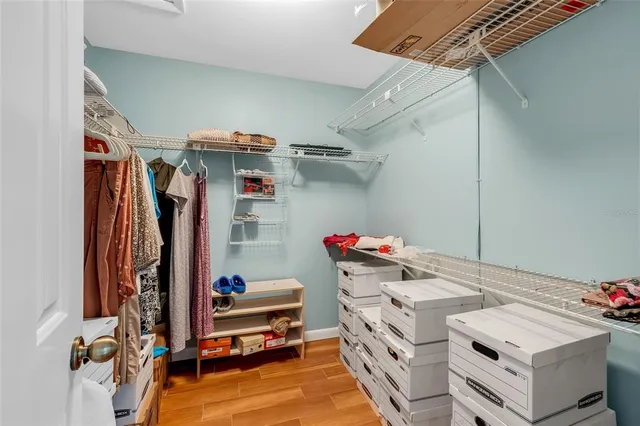a view of a hallway with wooden floor and furniture