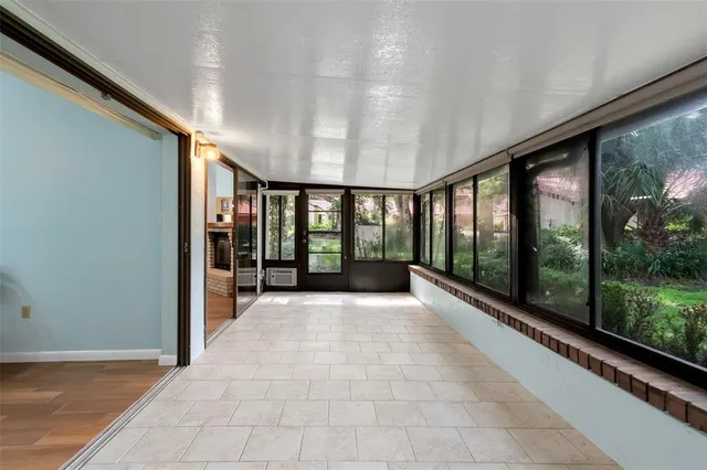 a view of a house with brick walls and a yard with plants