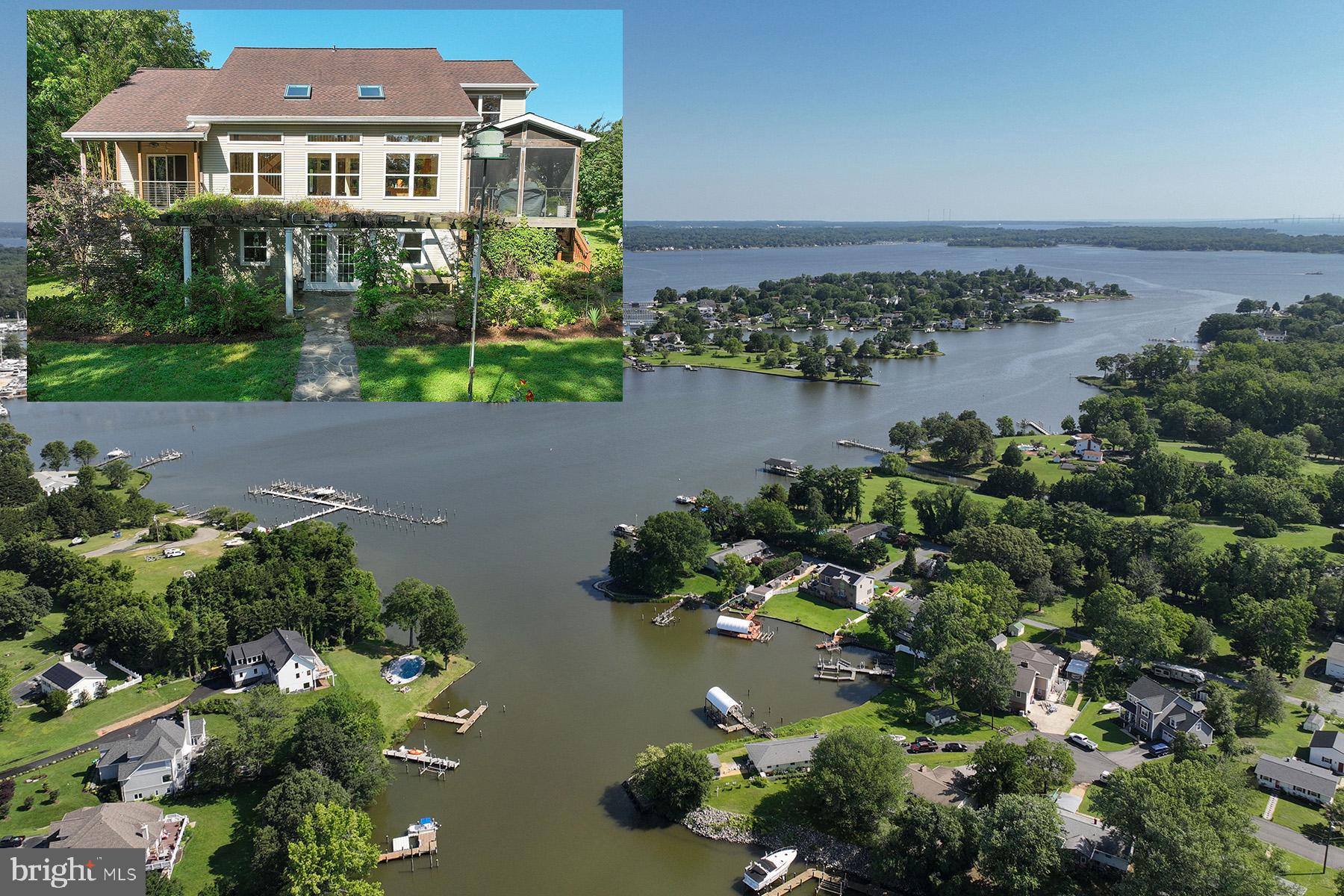 an aerial view of a house with a garden and lake view