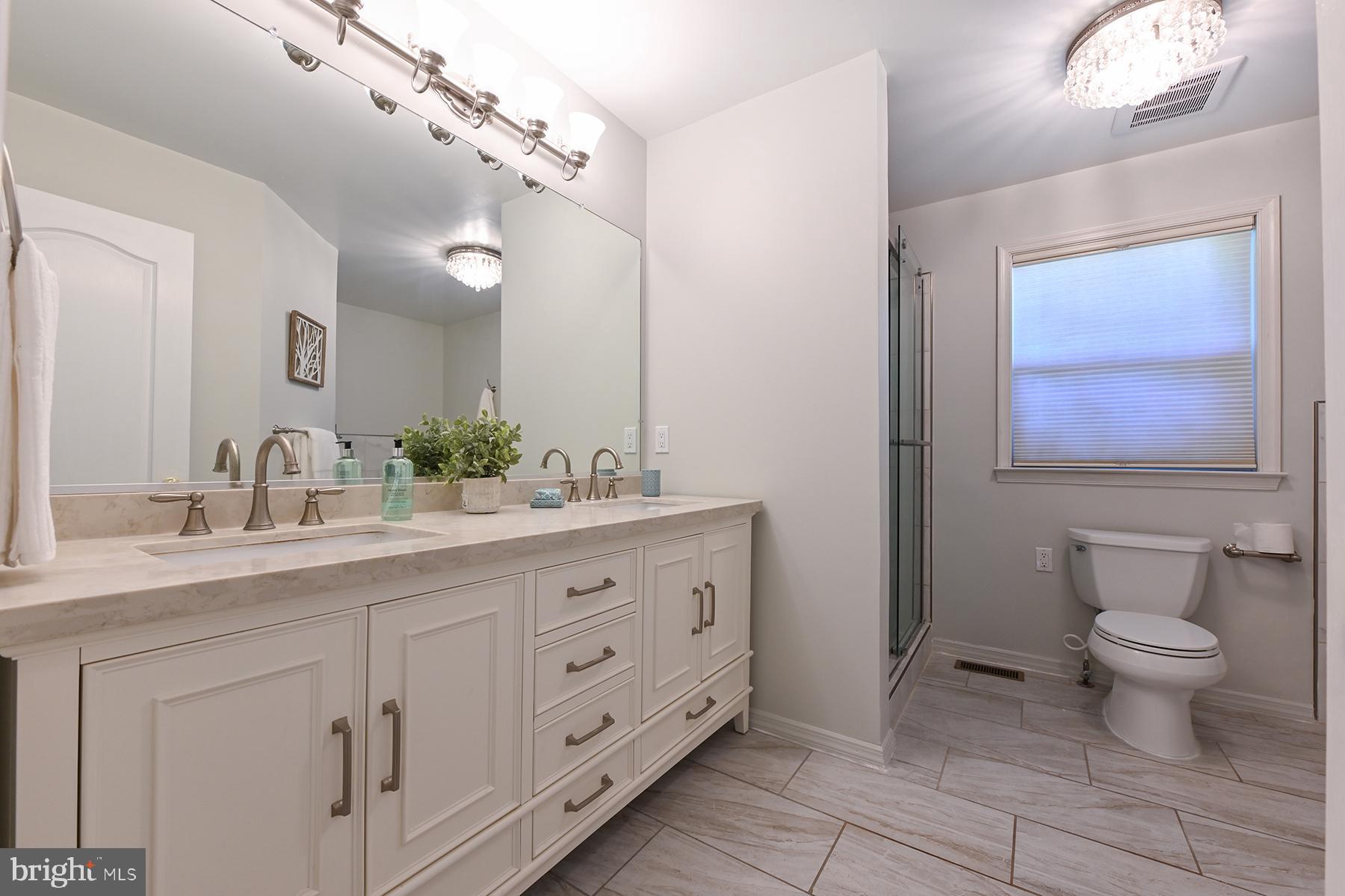 4119 Waterview Drive Edgewater, MD 21037 - Photo 13 of 20 a bathroom with a double vanity sink and a mirror