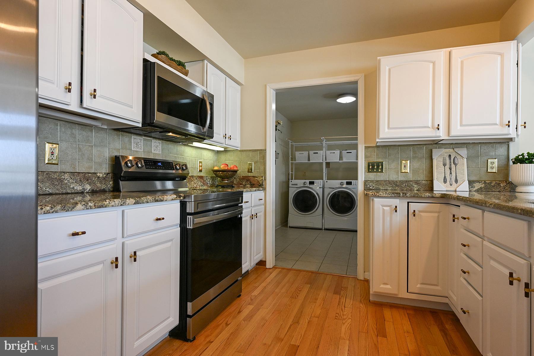 4119 Waterview Drive Edgewater, MD 21037 - Photo 8 of 20 a kitchen with stainless steel appliances granite countertop a refrigerator stove and white cabinets