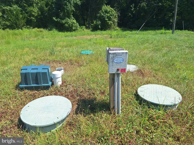 a backyard of a house with a yard and outdoor seating