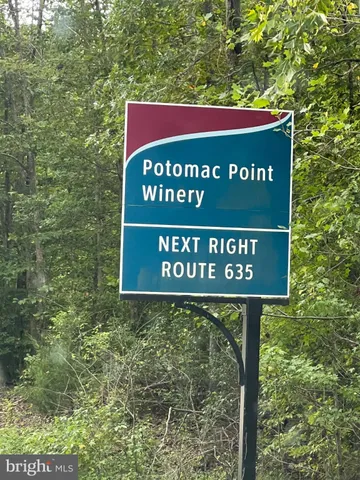 a sign broad in front of a red brick house