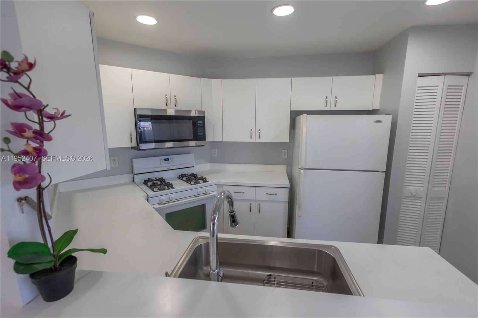 16831 Southwest 139th Place Miami, FL 33177 - Photo 14 of 39 a kitchen with a refrigerator and a sink