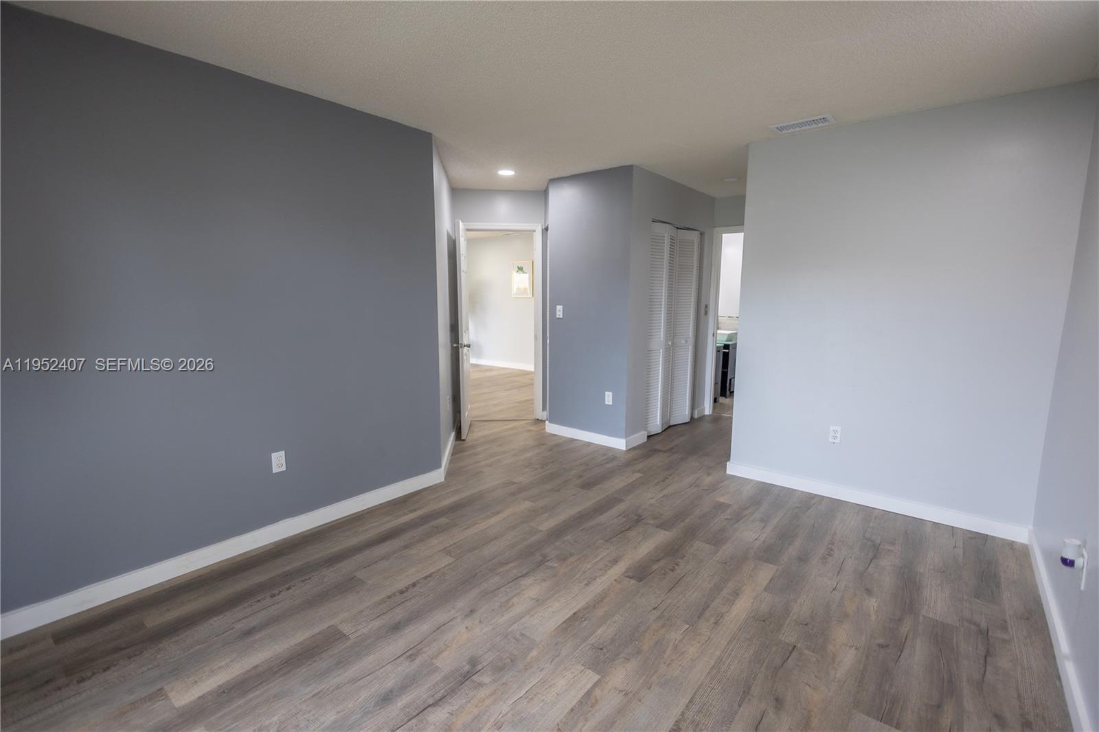 16831 Southwest 139th Place Miami, FL 33177 - Photo 17 of 39 a view of an empty room with wooden floor
