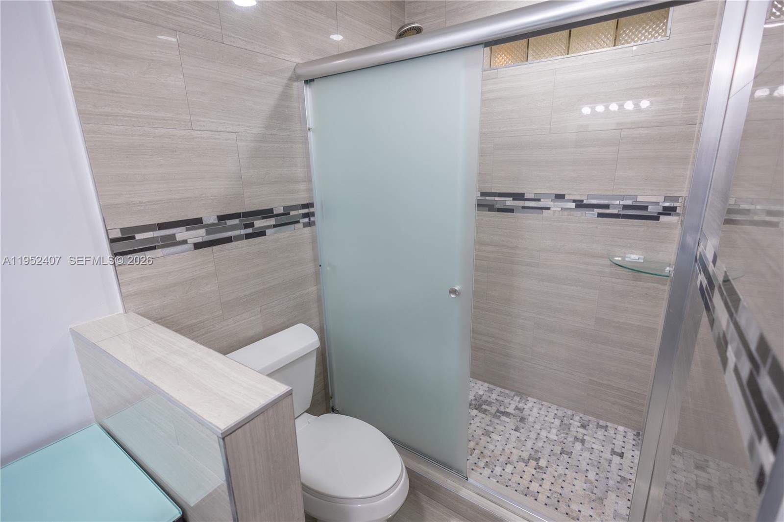 16831 Southwest 139th Place Miami, FL 33177 - Photo 18 of 39 a white toilet sitting next to a shower