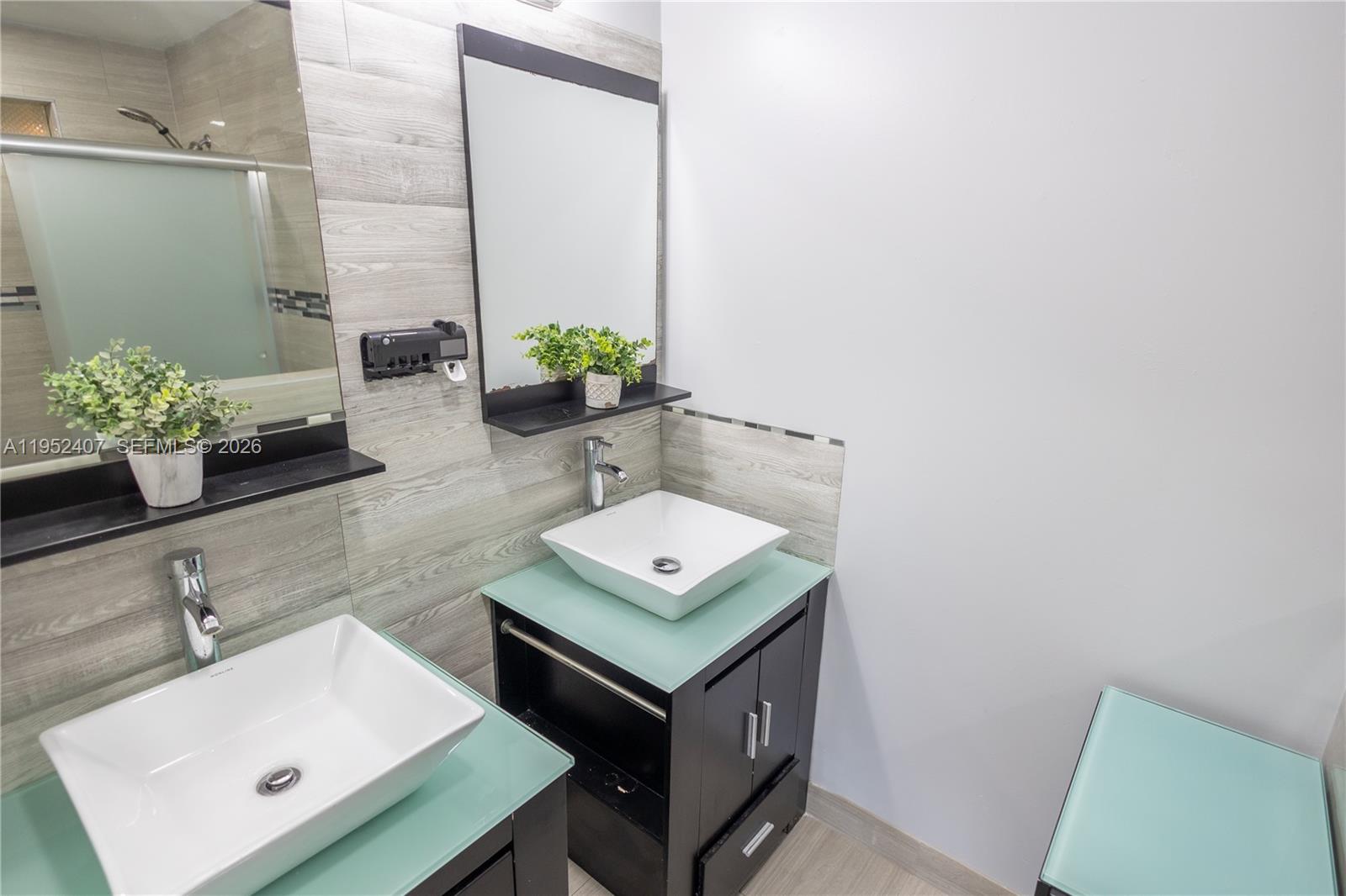 16831 Southwest 139th Place Miami, FL 33177 - Photo 19 of 39 a bathroom with a sink a mirror and potted plant