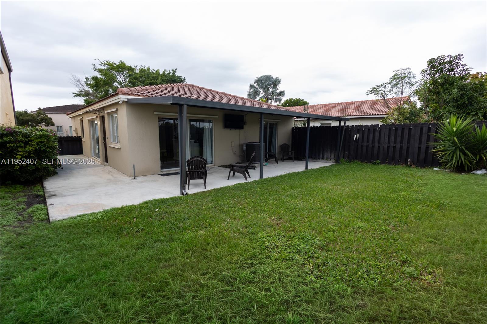 16831 Southwest 139th Place Miami, FL 33177 - Photo 33 of 39 a view of a house with a yard and furniture