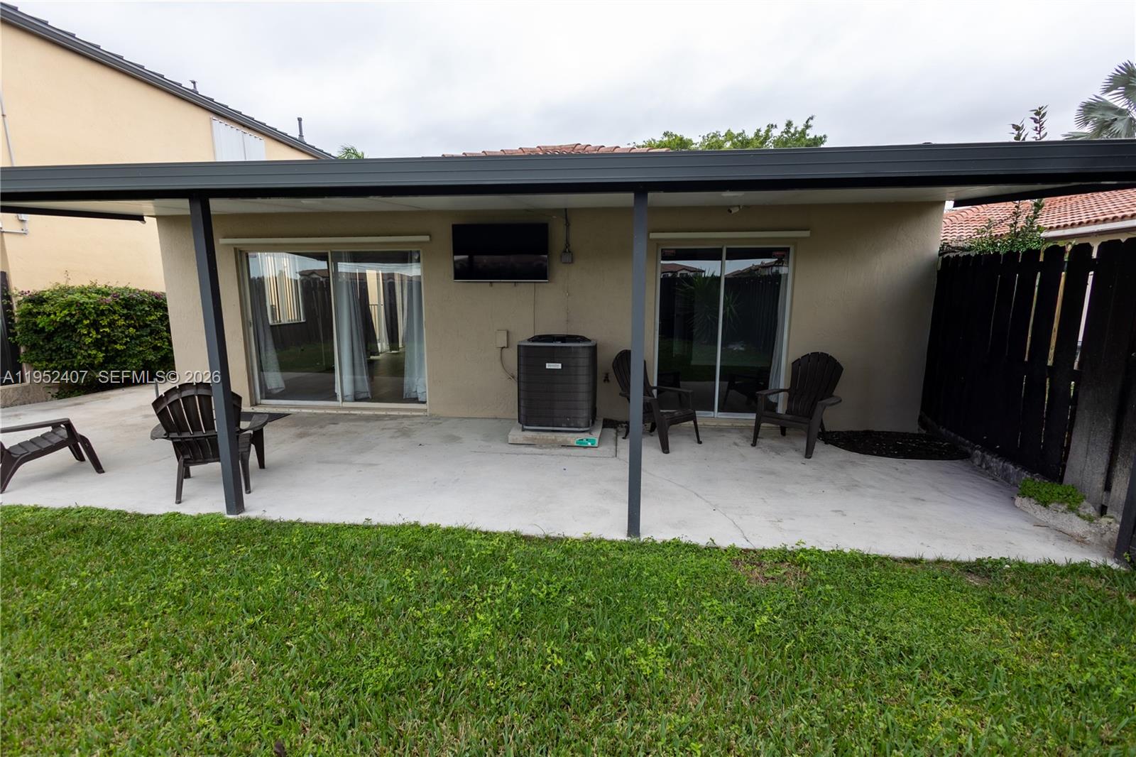 16831 Southwest 139th Place Miami, FL 33177 - Photo 35 of 39 a view of a porch with furniture and a yard