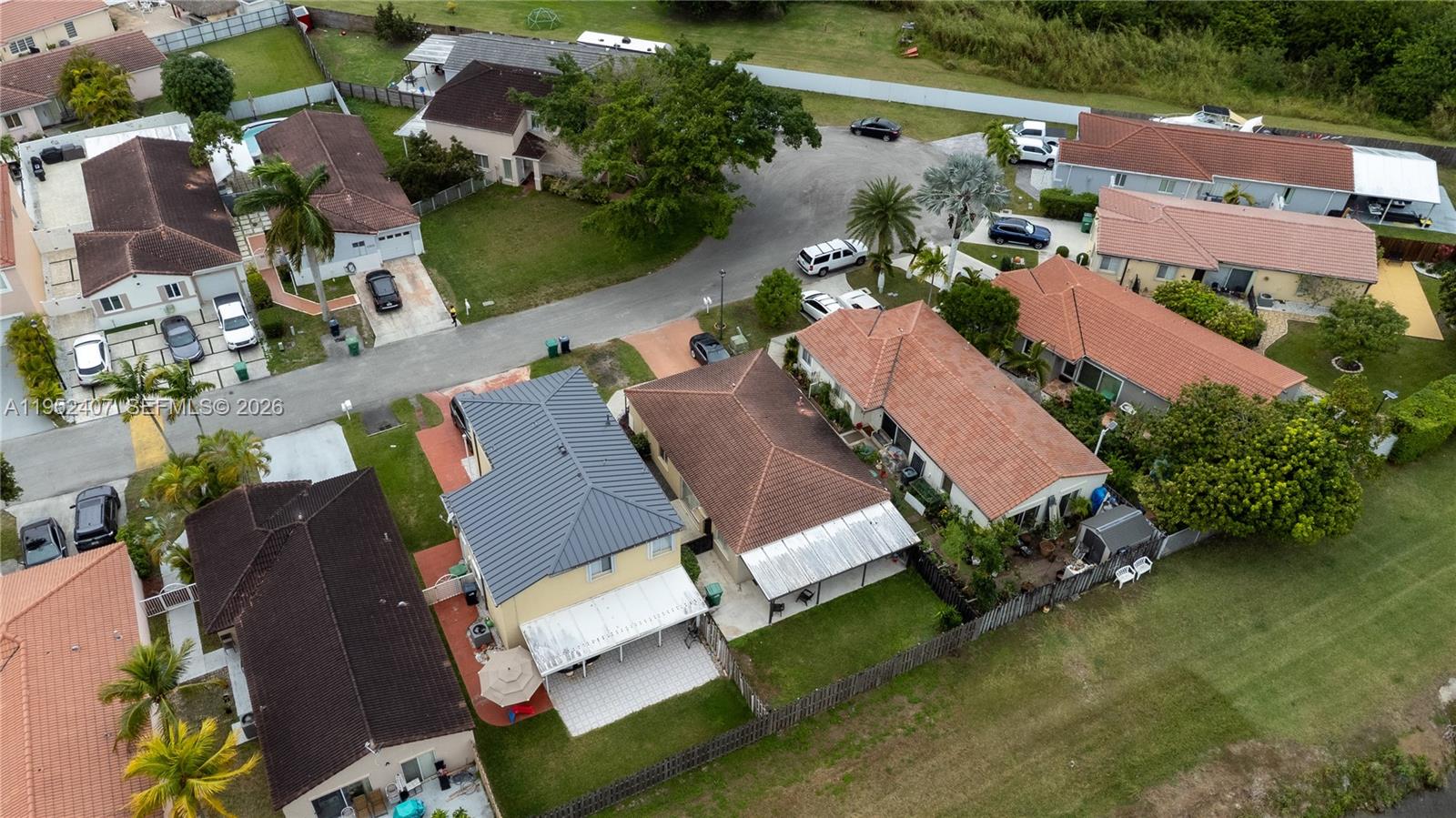 16831 Southwest 139th Place Miami, FL 33177 - Photo 36 of 39 an aerial view of a house with a garden and lake view