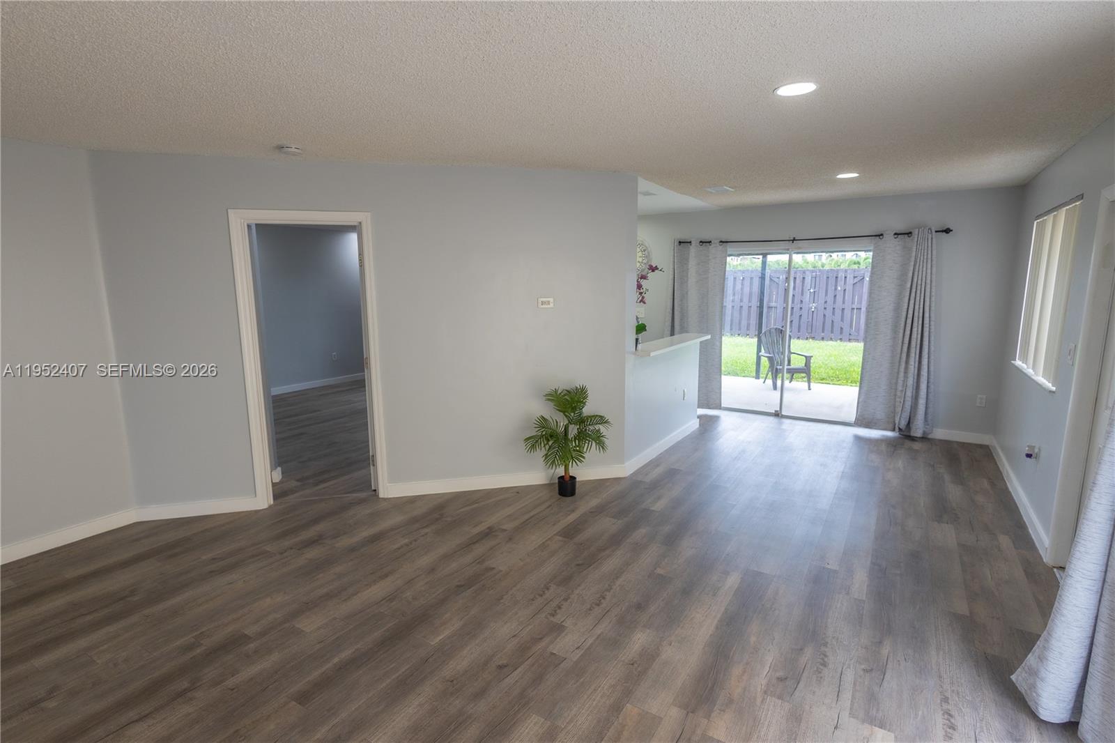 16831 Southwest 139th Place Miami, FL 33177 - Photo 10 of 39 an empty room with wooden floor and a window