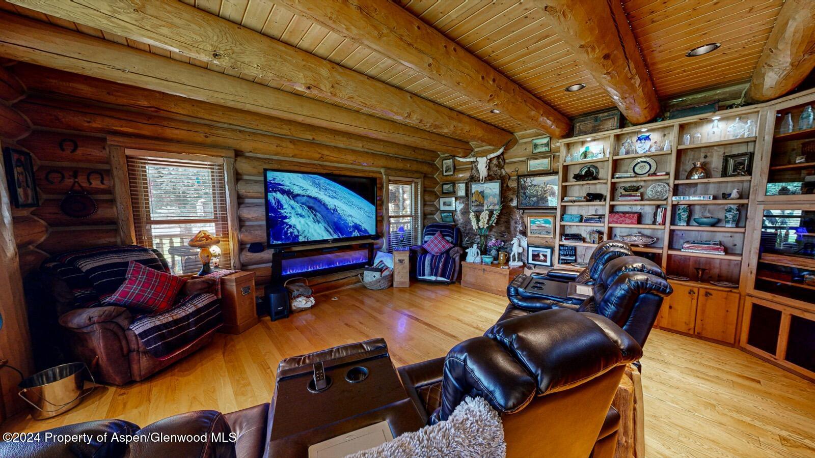 56106 Me Road Collbran, CO 81624 - Photo 11 of 34 a living room with furniture a rug and a chandelier