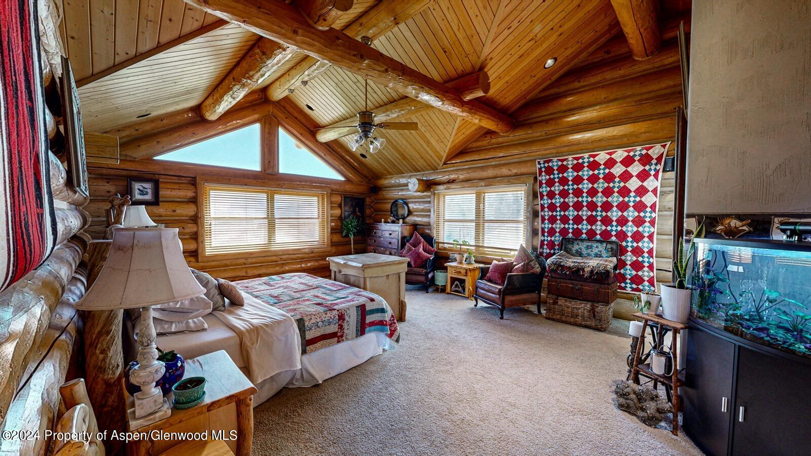 56106 Me Road Collbran, CO 81624 - Photo 20 of 34 a bedroom with furniture and a chandelier