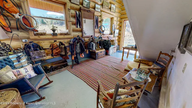 a living room with furniture a rug and a window