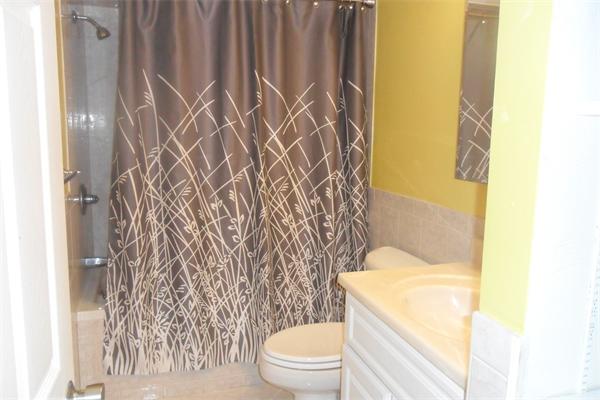 30 Adams Road Ashland, MA 01721 - Photo 15 of 20 a white toilet sitting next to a shower curtain