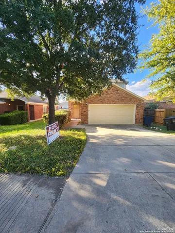 a front view of a house with a yard and a garage