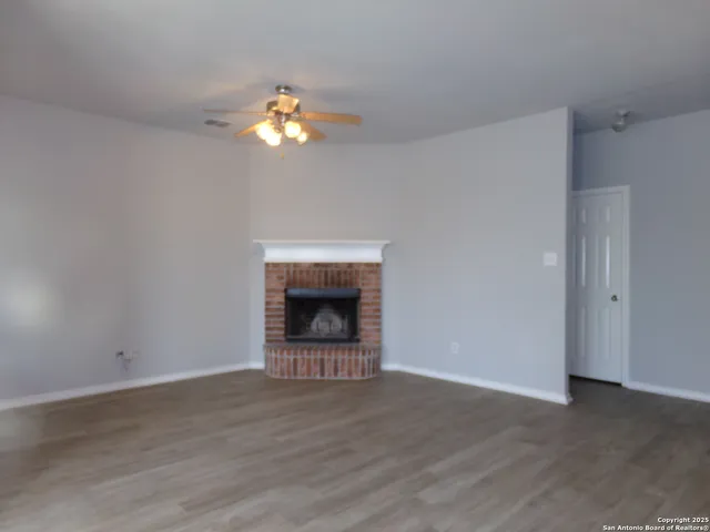 a view of an empty room with a fireplace