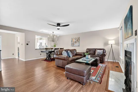 a living room with furniture wooden floor and a flat screen tv