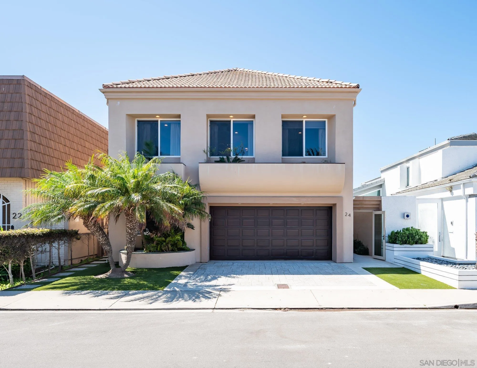 24 Sandpiper Strand Coronado, CA 92118 - Photo 1 of 56 a front view of a house with a yard and garage