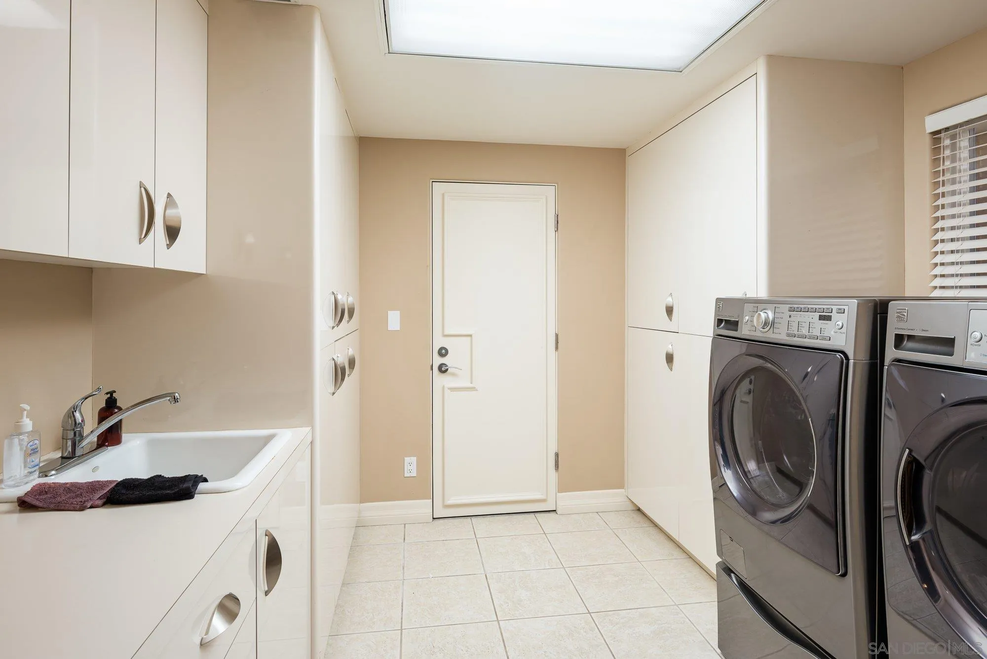 24 Sandpiper Strand Coronado, CA 92118 - Photo 11 of 56 a utility room with sink dryer and washer