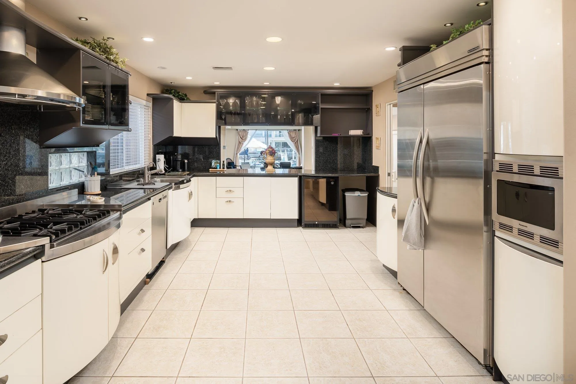 24 Sandpiper Strand Coronado, CA 92118 - Photo 12 of 56 a large kitchen with stainless steel appliances kitchen island granite countertop a refrigerator and a stove top oven