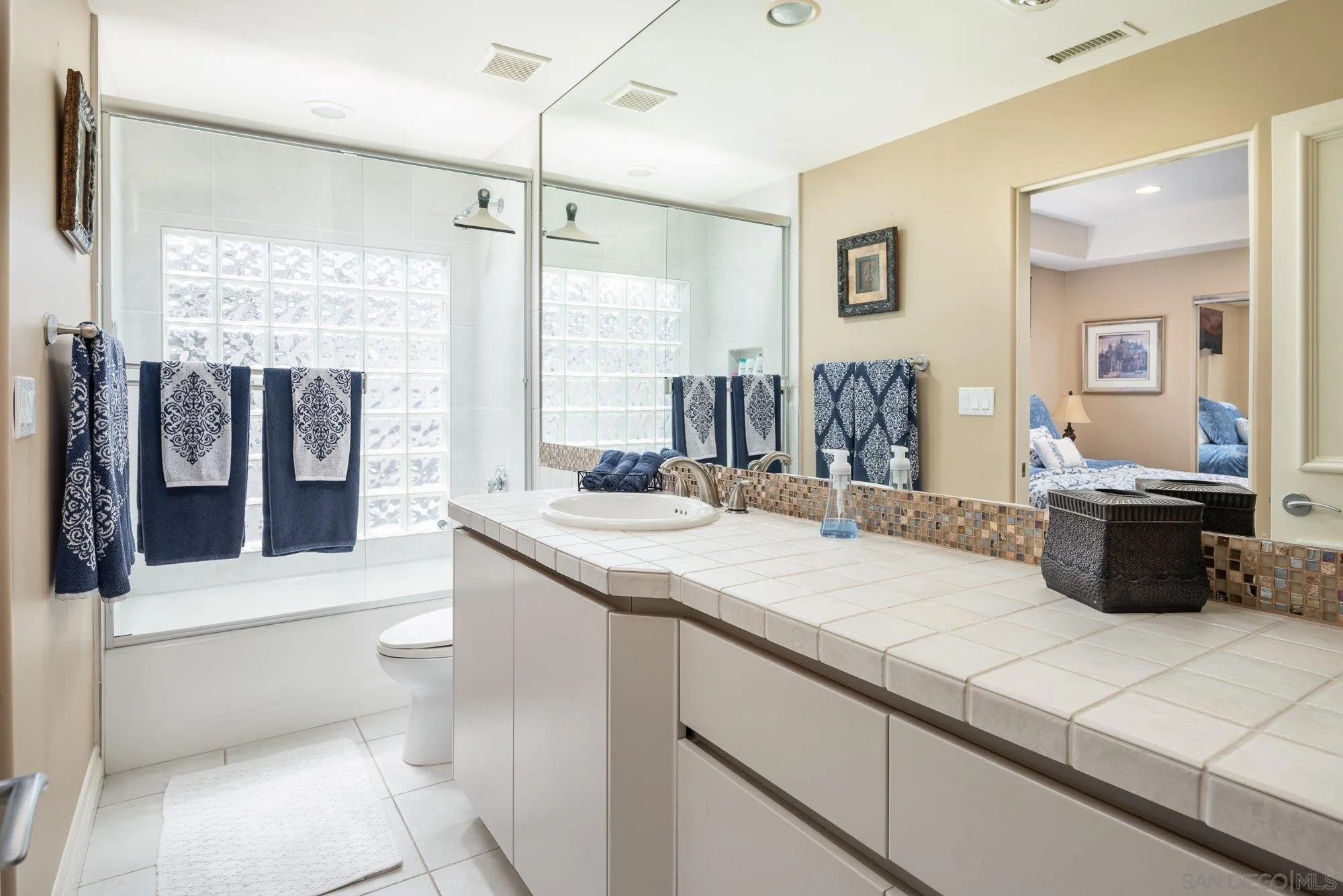 24 Sandpiper Strand Coronado, CA 92118 - Photo 26 of 56 a bathroom with a double vanity sink toilet and shower