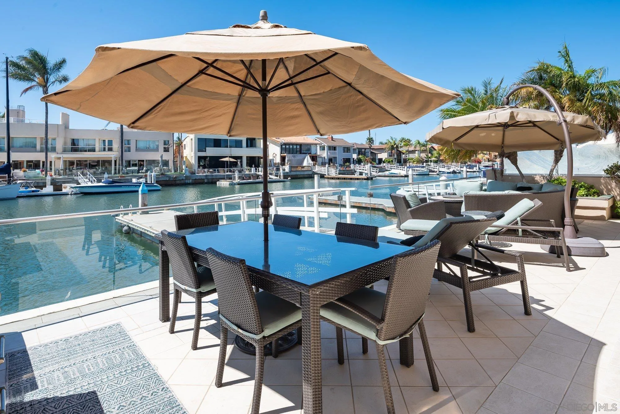24 Sandpiper Strand Coronado, CA 92118 - Photo 39 of 56 a view of a patio with chairs and table under an umbrella