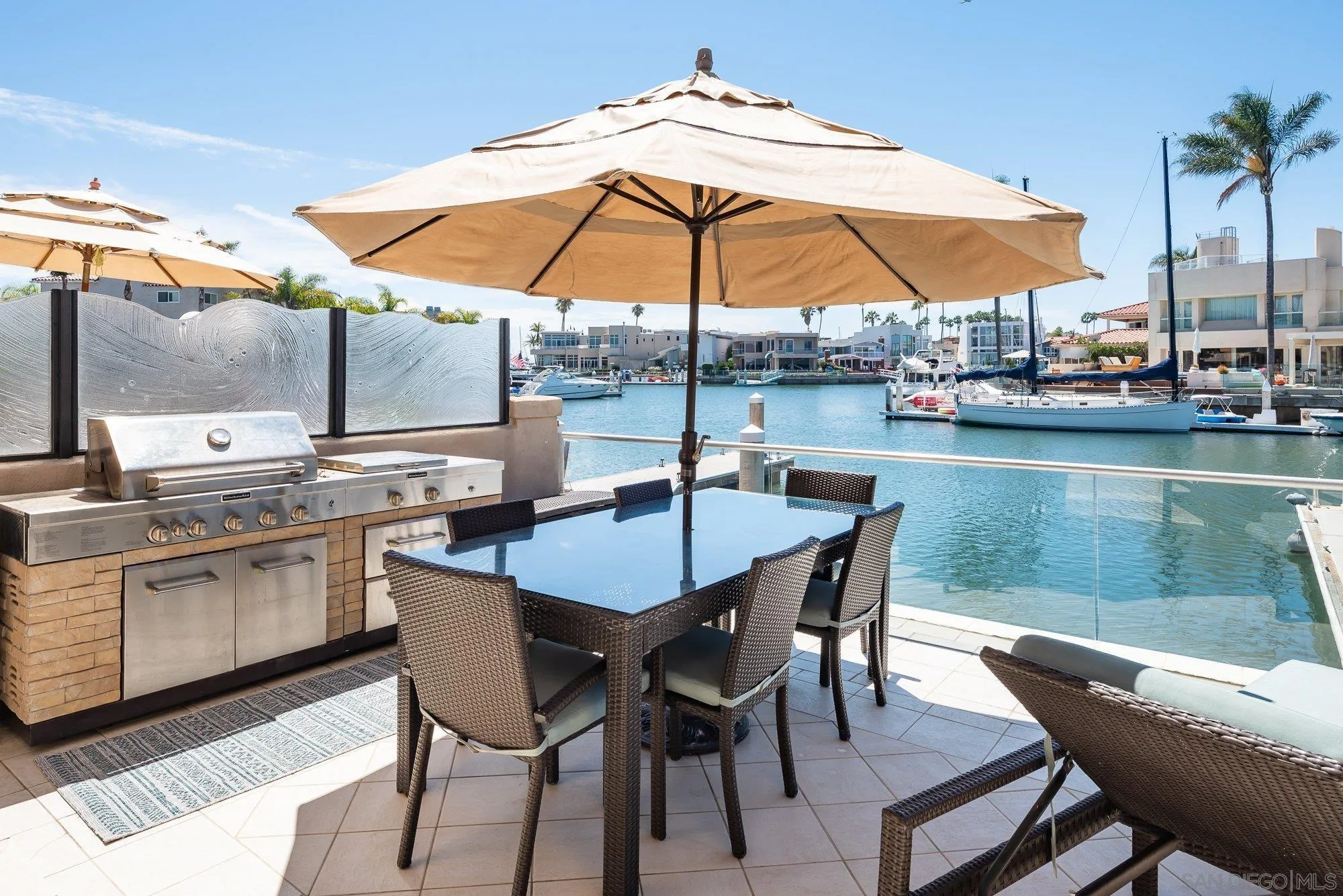 24 Sandpiper Strand Coronado, CA 92118 - Photo 42 of 56 a view of a patio with furniture and umbrella