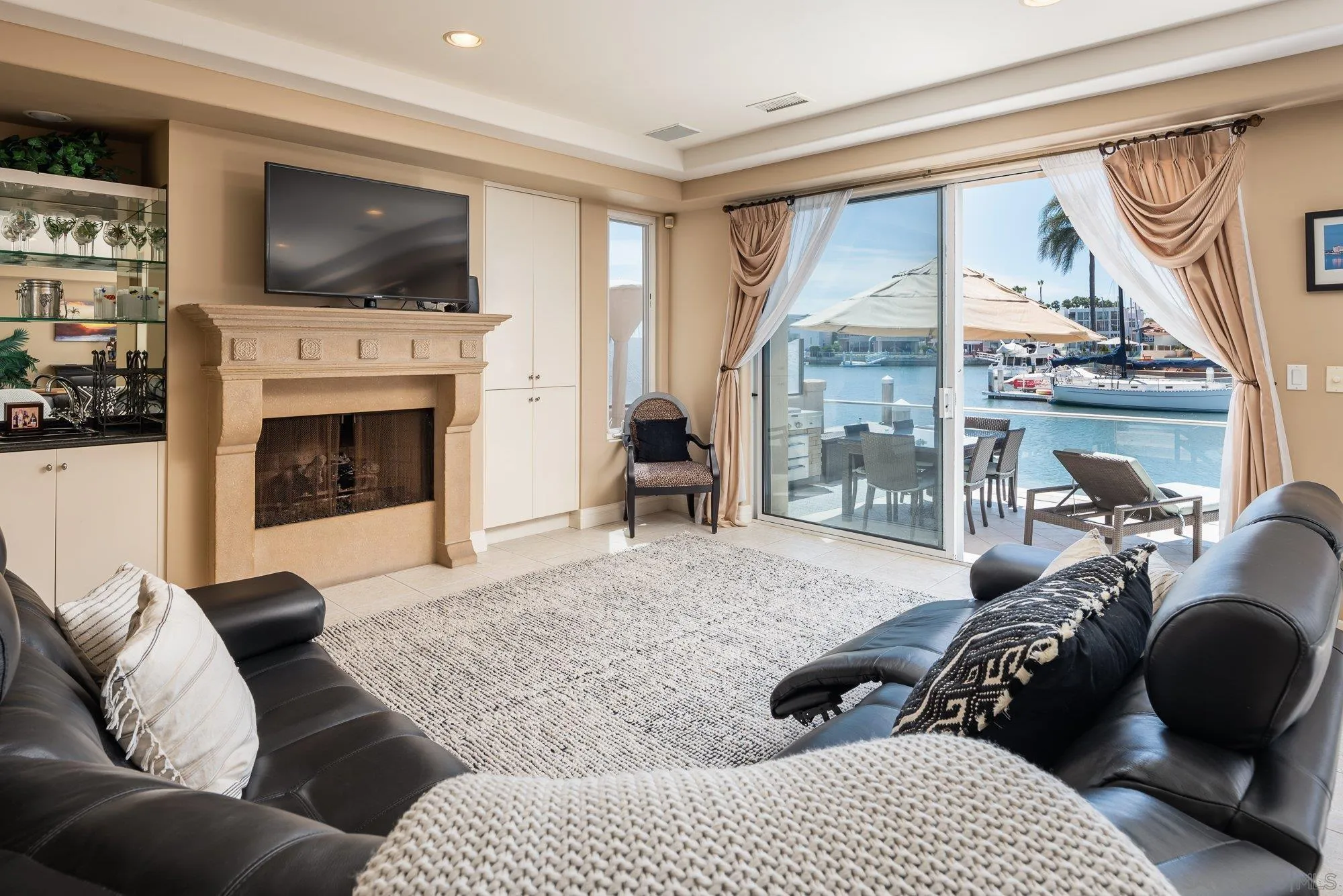 24 Sandpiper Strand Coronado, CA 92118 - Photo 5 of 56 a living room with furniture fireplace and a flat screen tv