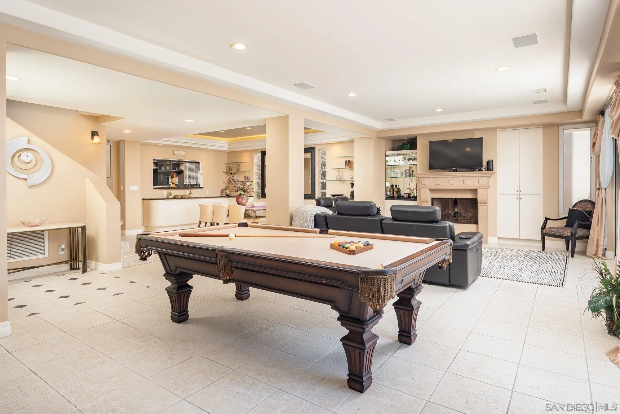 24 Sandpiper Strand Coronado, CA 92118 - Photo 7 of 56 a living room with table chairs and flat screen tv