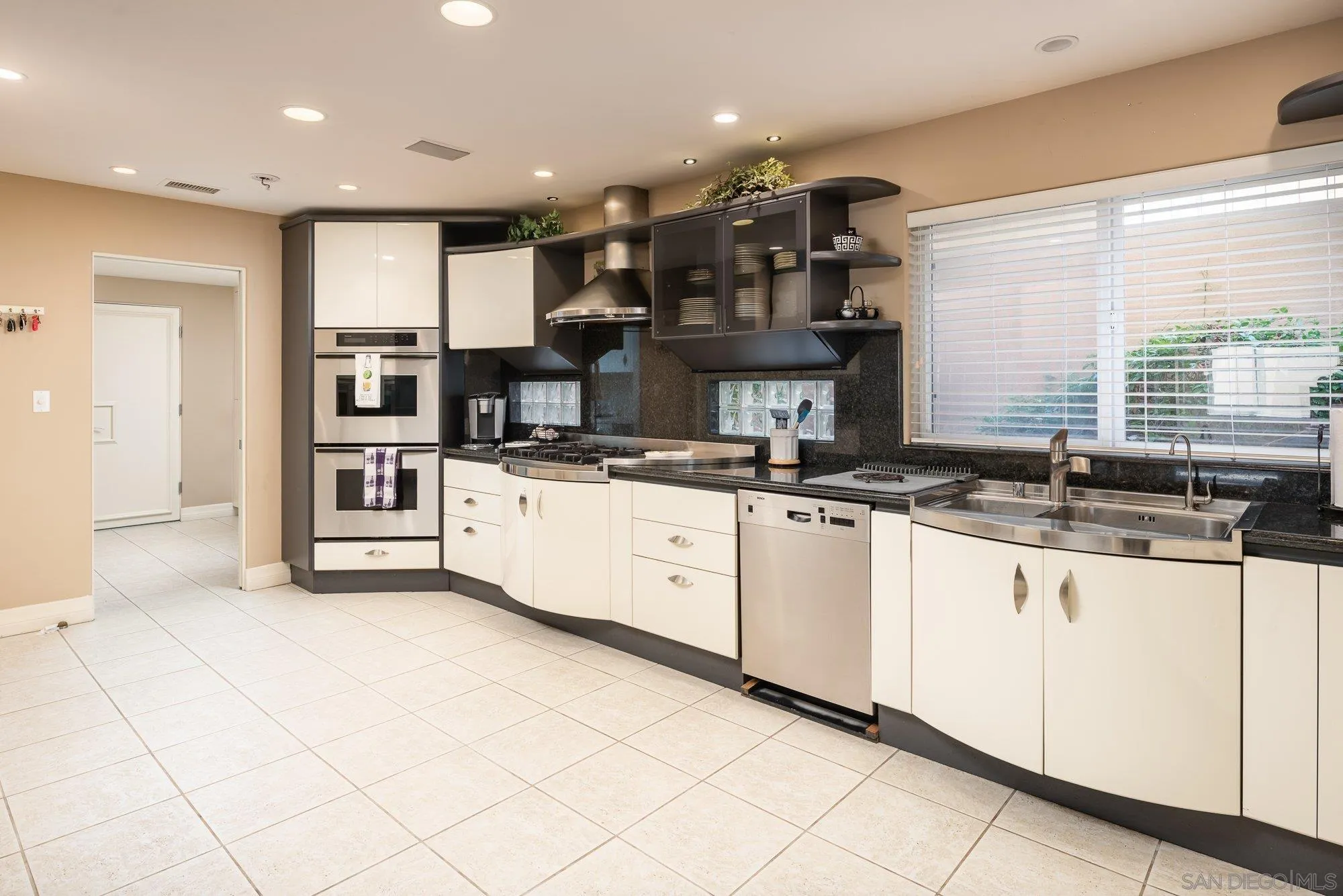 24 Sandpiper Strand Coronado, CA 92118 - Photo 9 of 56 a kitchen with stainless steel appliances kitchen island granite countertop a sink and cabinets
