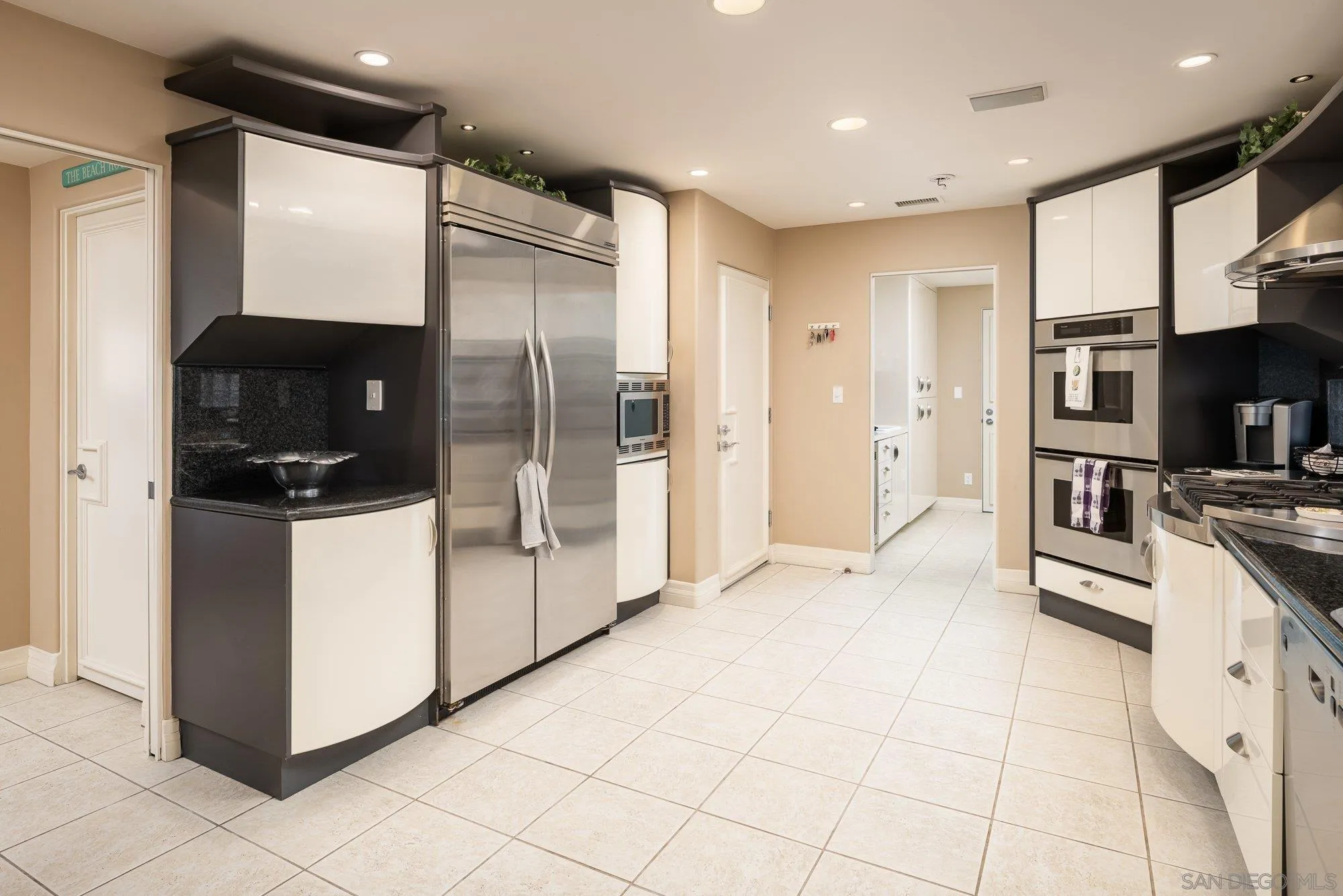 24 Sandpiper Strand Coronado, CA 92118 - Photo 10 of 56 a kitchen with stainless steel appliances a refrigerator and a stove top oven