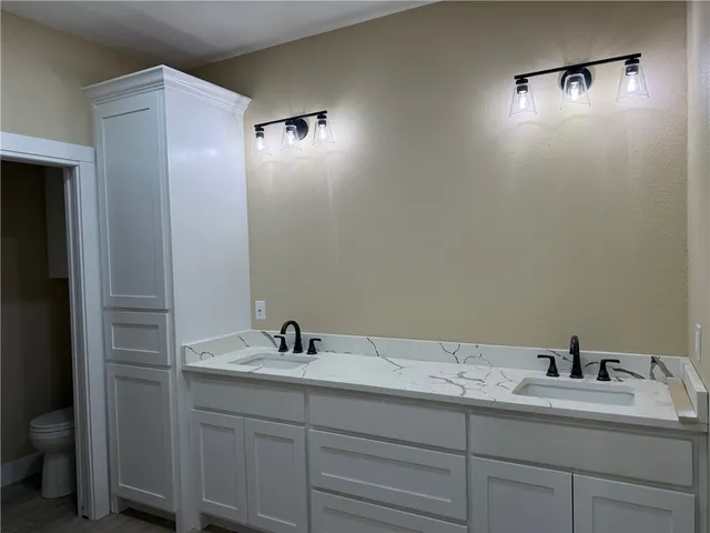 a view of a hallway with windows and stairs