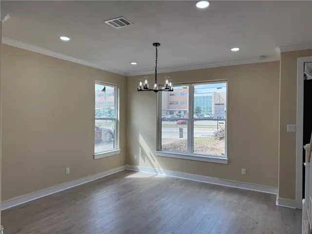 a view of a hallway with stairs and a kitchen view