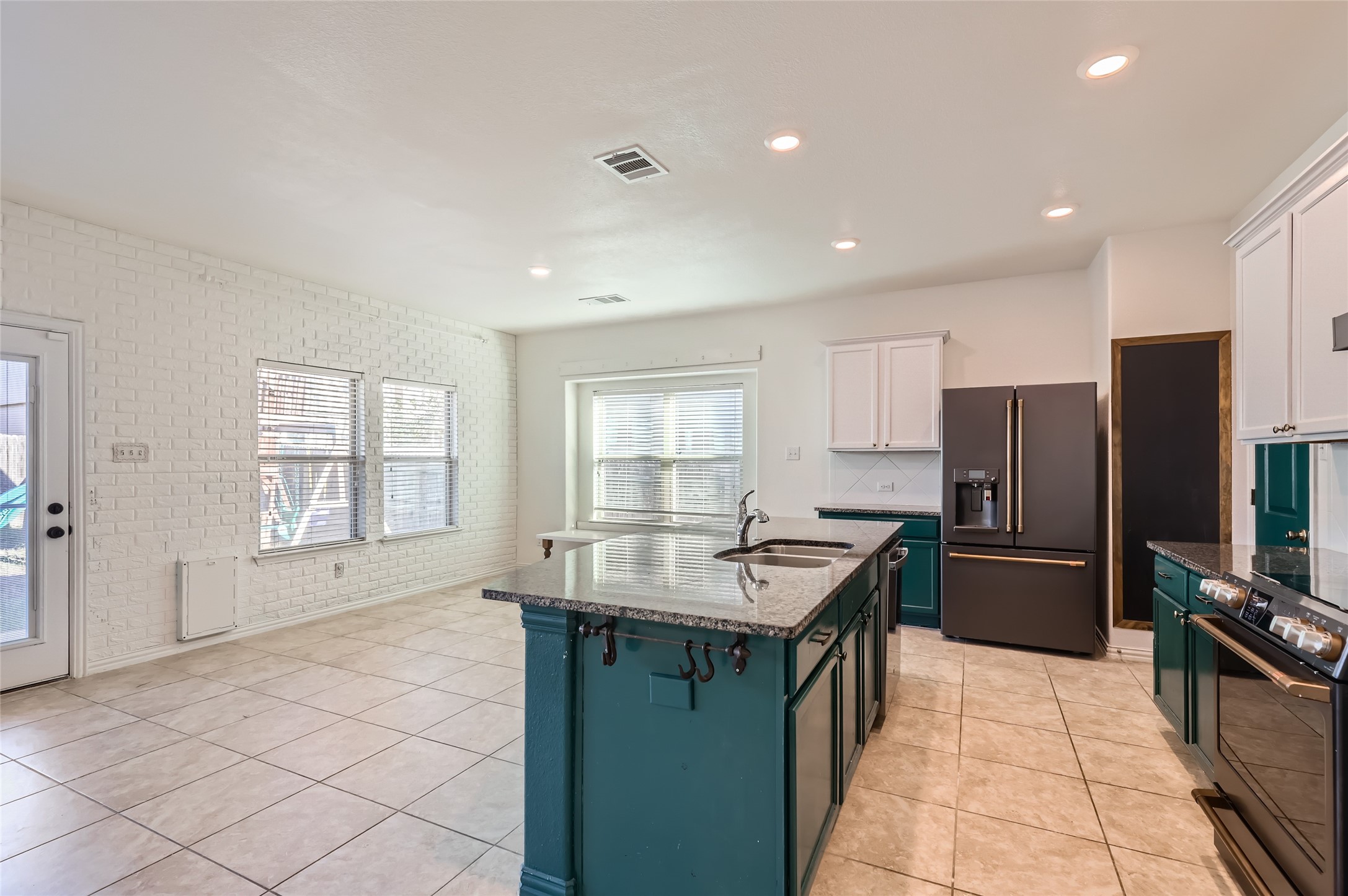 153 Ammonite Lane Jarrell, TX 76537 - Photo 9 of 26 a kitchen with stainless steel appliances granite countertop a sink stove and refrigerator