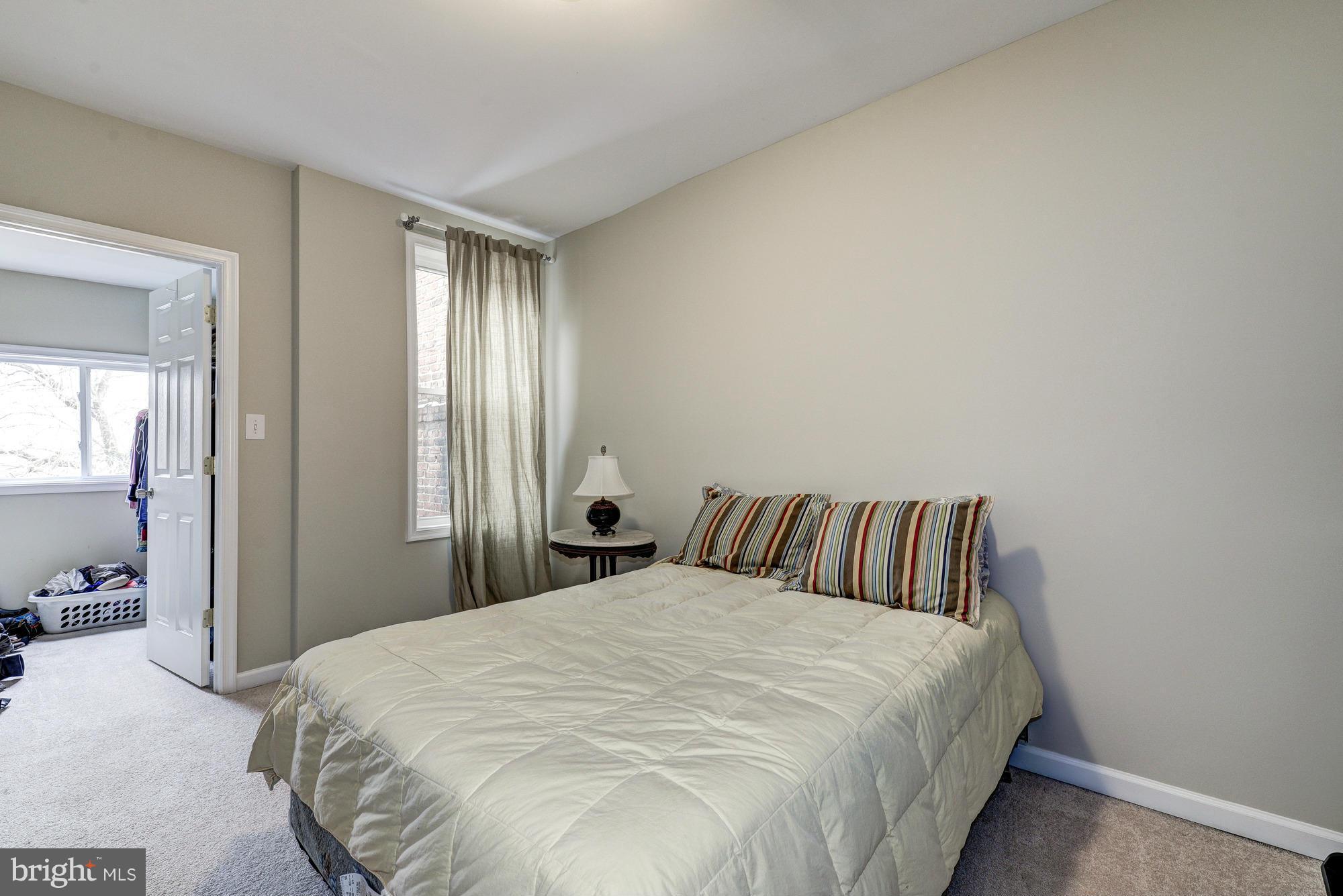 2017 2nd Street Northeast Washington, DC 20002 - Photo 13 of 23 a bedroom with a bed and large mirror