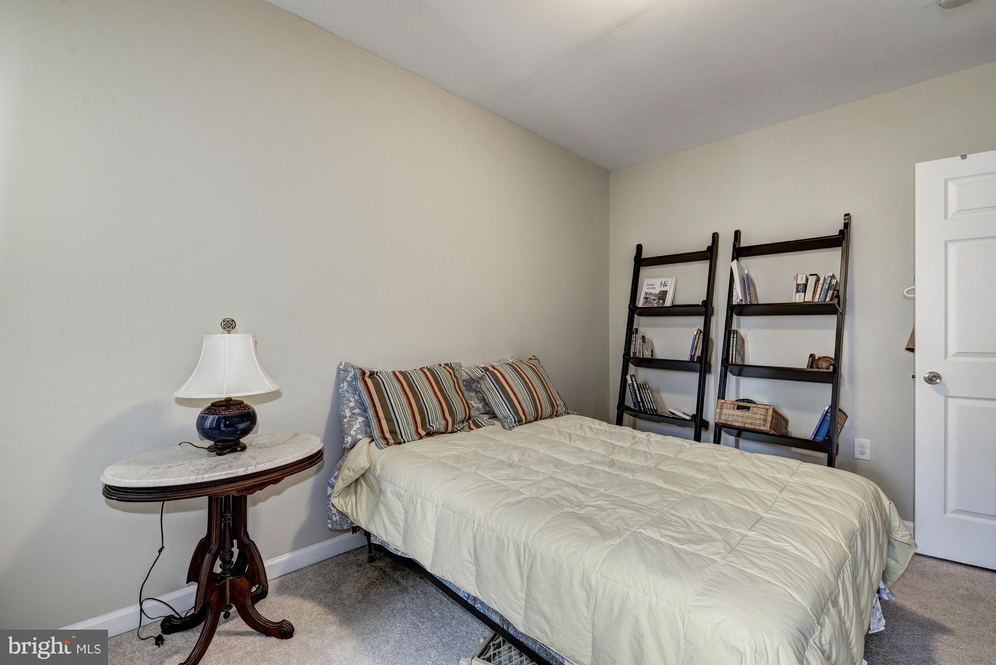 2017 2nd Street Northeast Washington, DC 20002 - Photo 14 of 23 a bedroom with a bed and a chandelier