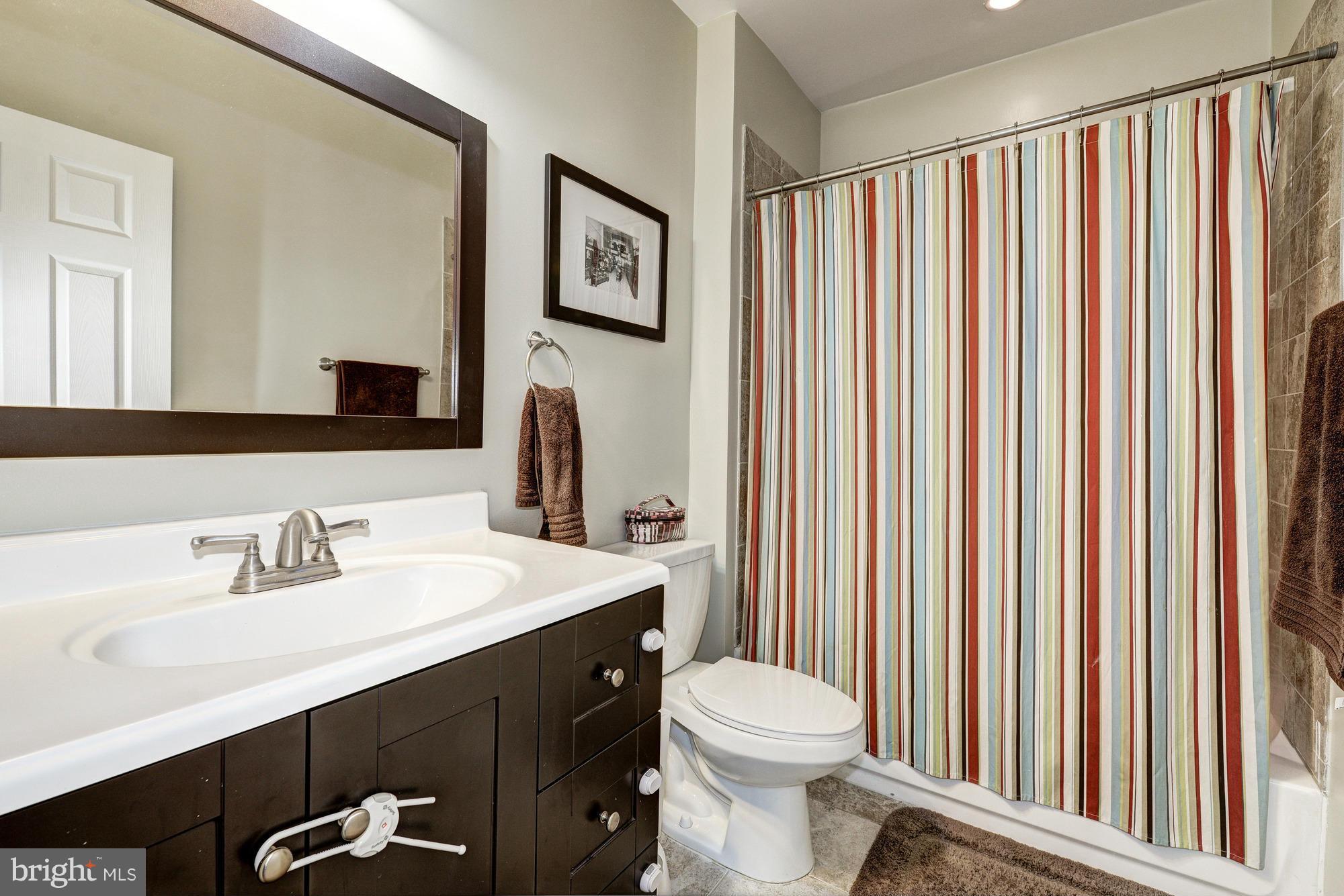 2017 2nd Street Northeast Washington, DC 20002 - Photo 15 of 23 a bathroom with a sink a toilet and mirror