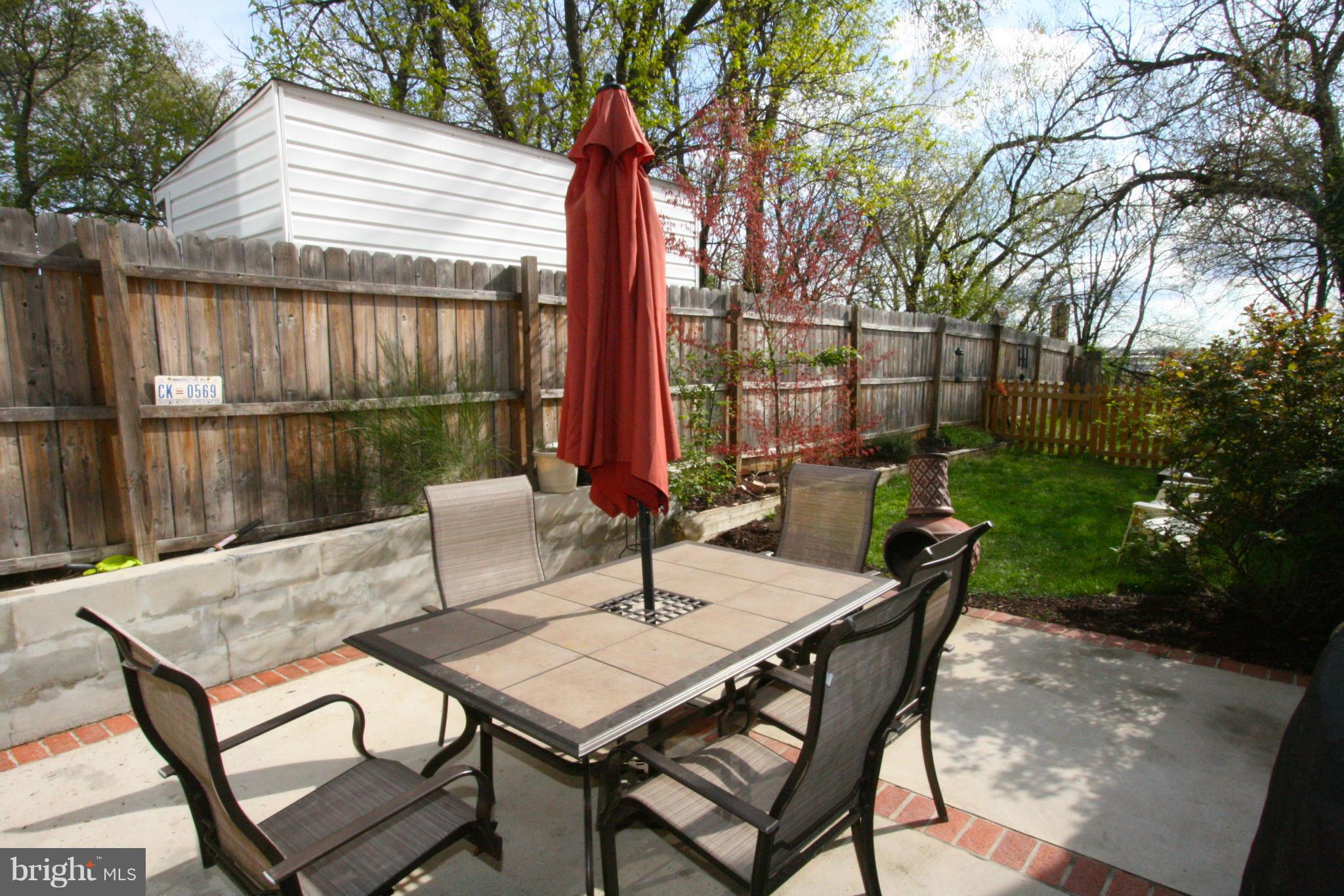 2017 2nd Street Northeast Washington, DC 20002 - Photo 22 of 23 a view of a patio with a table and chairs under an umbrella with wooden fence