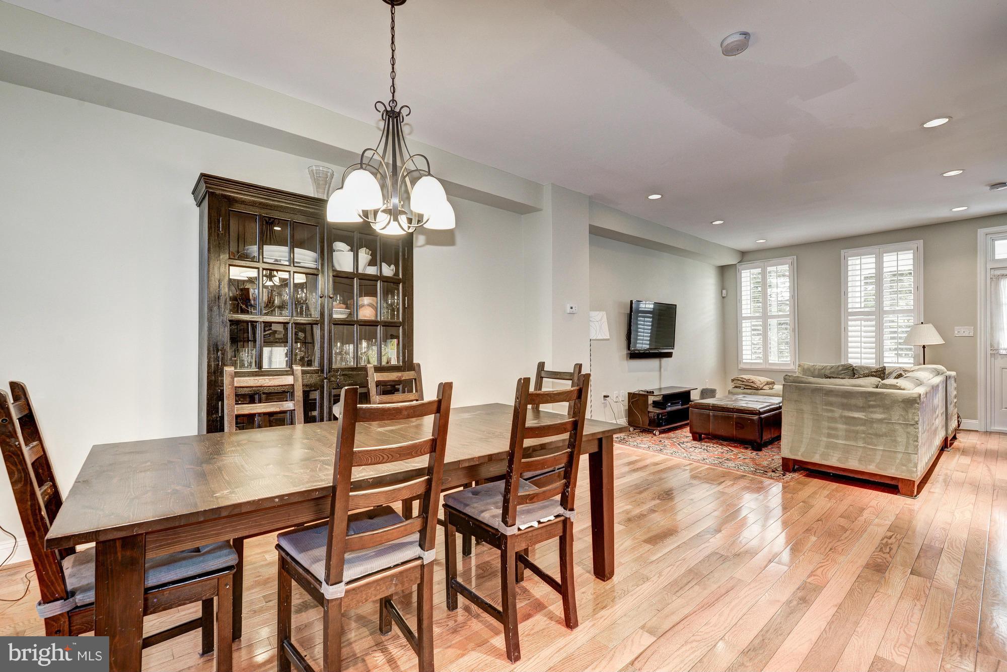 2017 2nd Street Northeast Washington, DC 20002 - Photo 7 of 23 a dining room with wooden floor a chandelier a wooden table and chairs