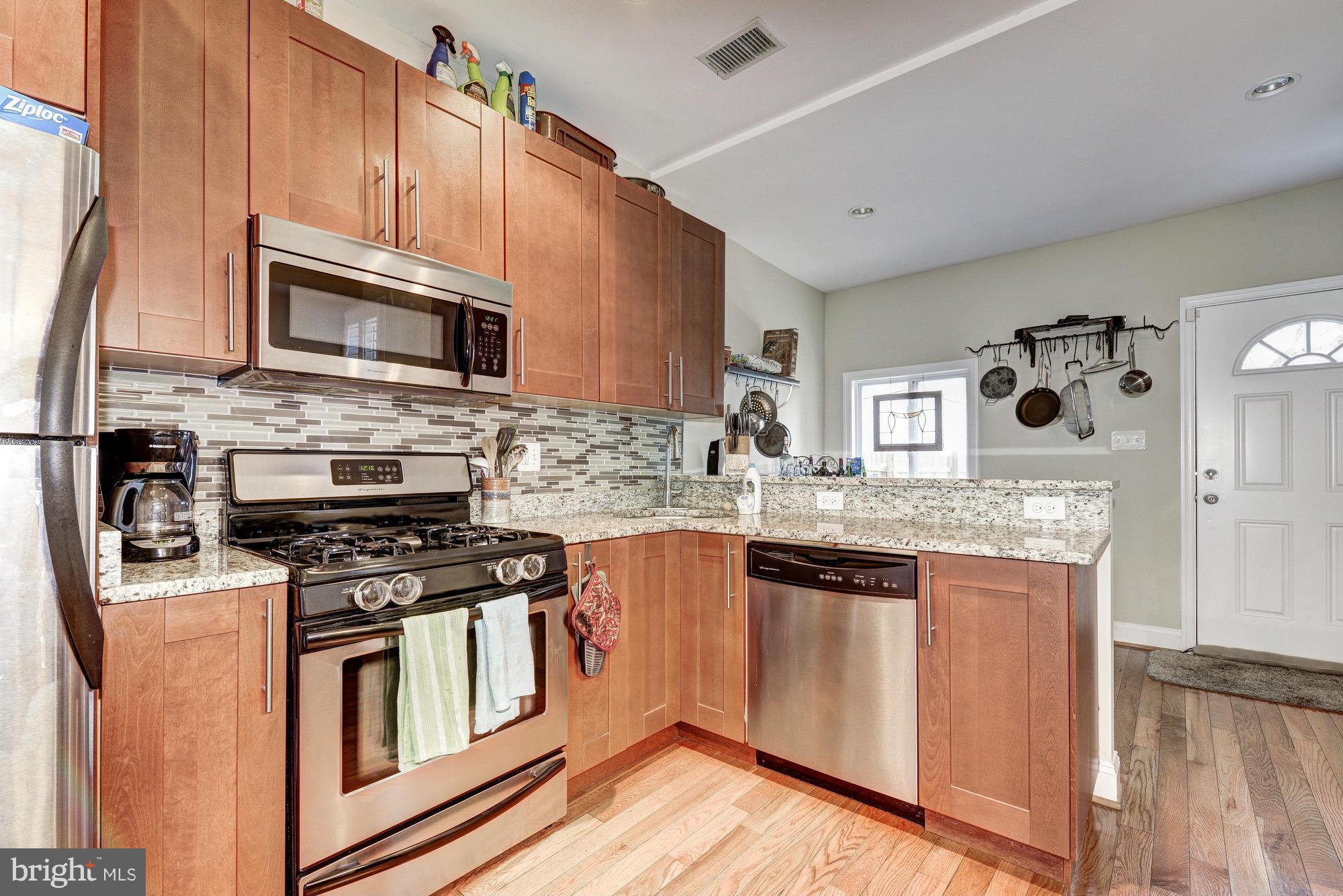 2017 2nd Street Northeast Washington, DC 20002 - Photo 9 of 23 a kitchen with stainless steel appliances granite countertop a stove microwave and sink