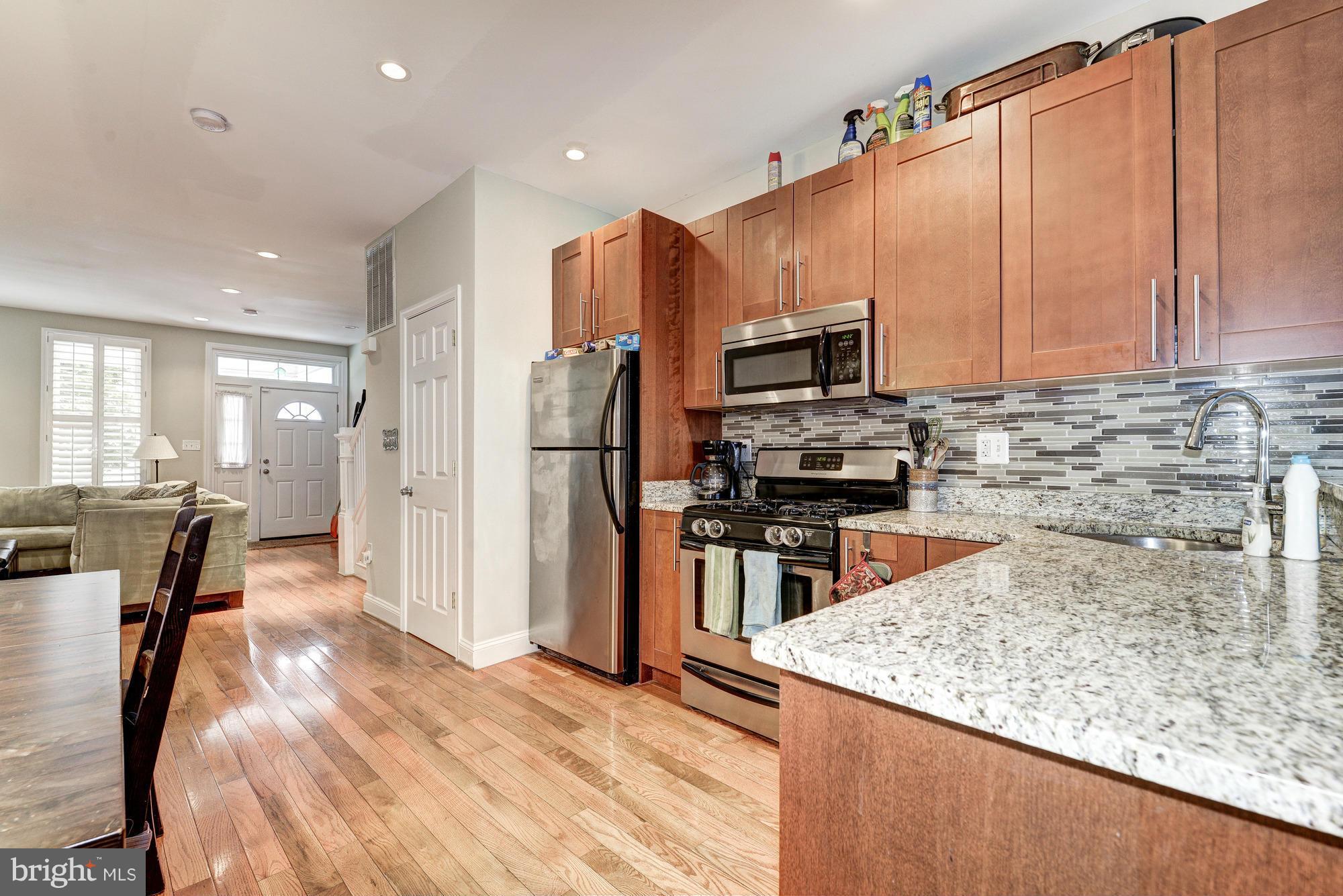 2017 2nd Street Northeast Washington, DC 20002 - Photo 10 of 23 a kitchen with stainless steel appliances granite countertop a refrigerator a stove top oven a sink and dishwasher